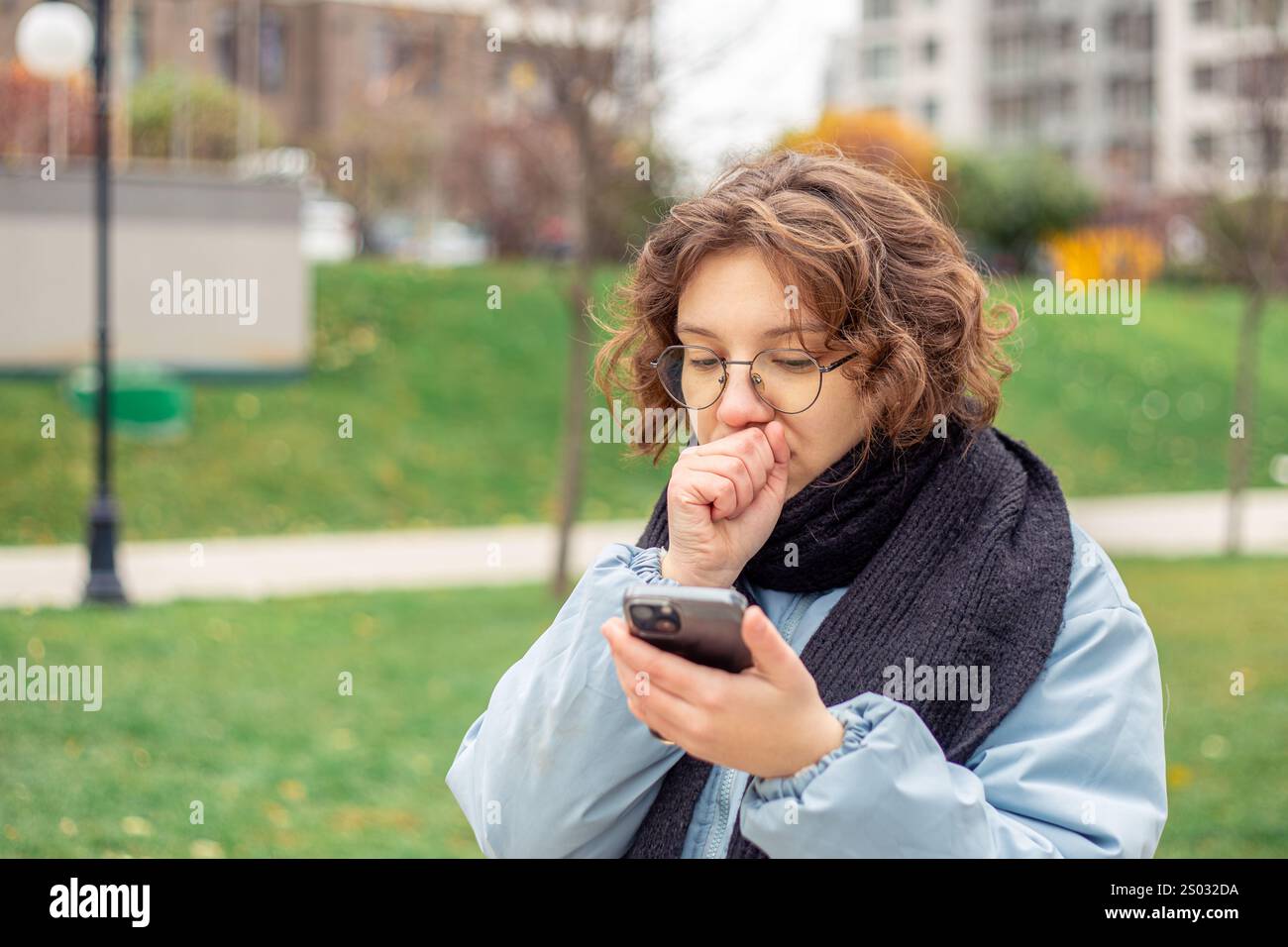 Freezing woman. A young beautiful frozen girl suffers from cold weather ...