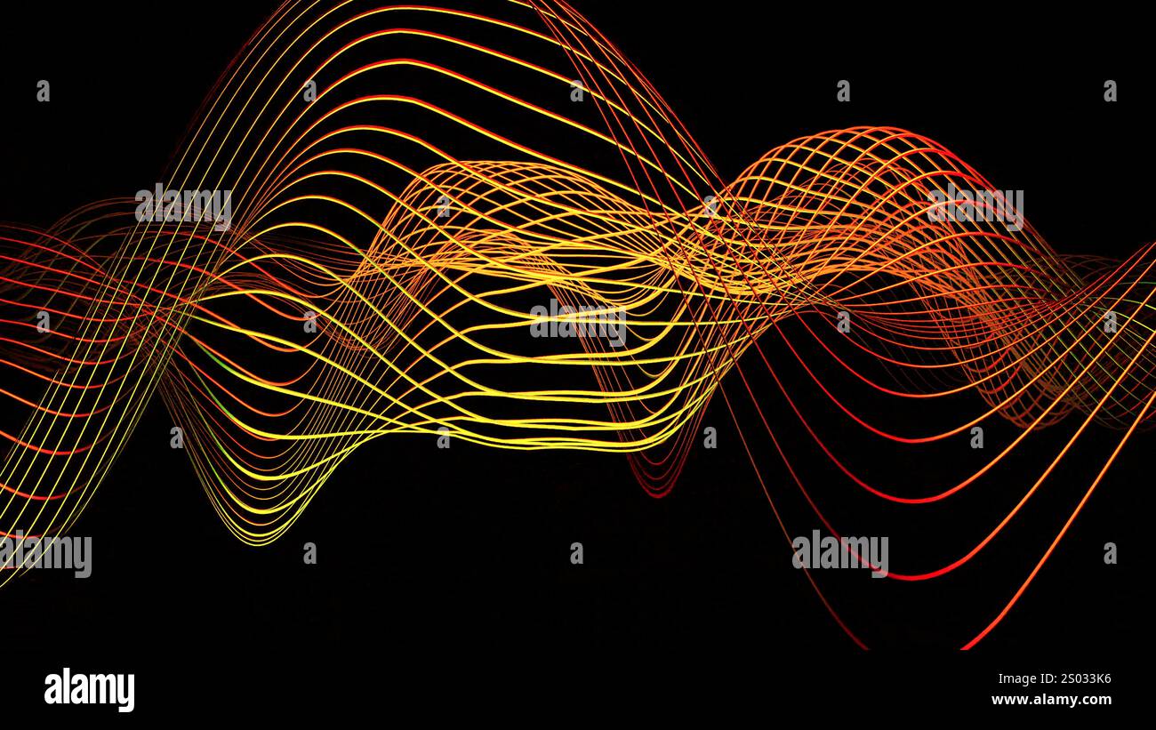 A mesmerizing wave of colorful lines flows on a black background ...