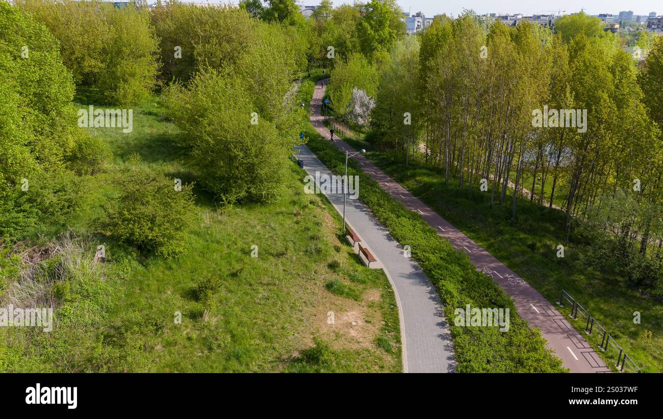 Aerial view of a lush green park with walking and cycling paths ...