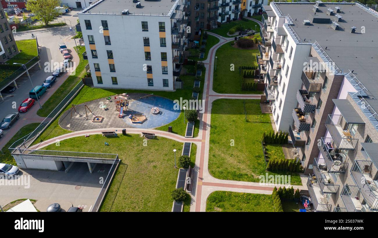 Aerial view of modern apartment buildings with a playground and green ...