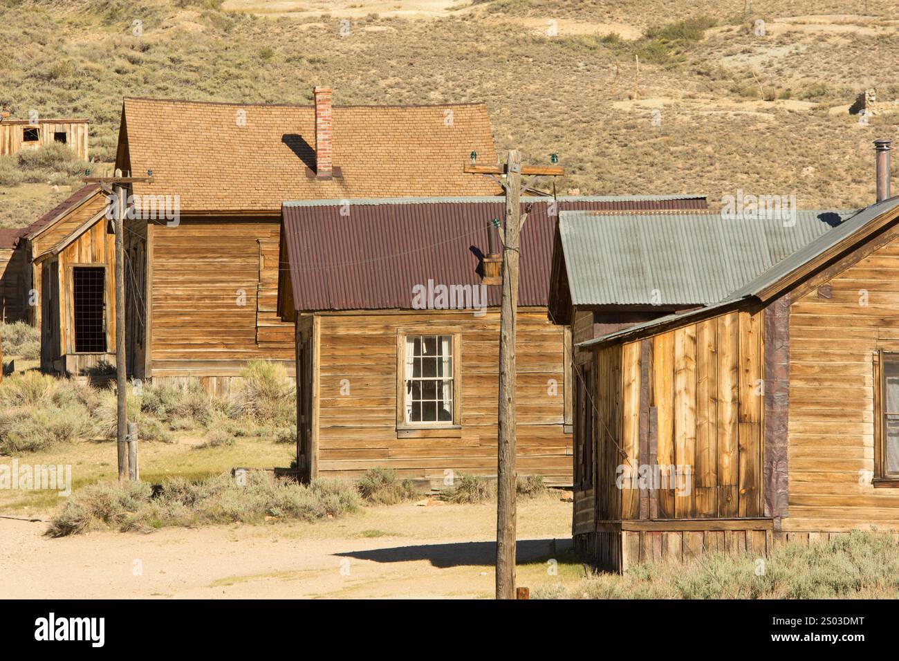 A row of old wooden houses with a few windows and a chimney. The houses ...