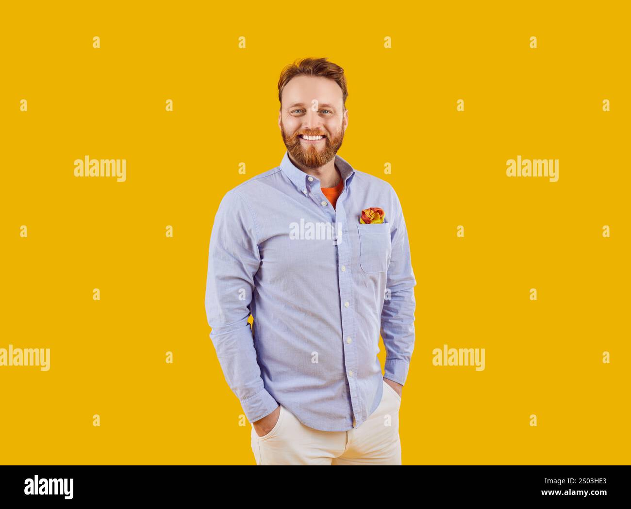 Portrait of a Smiling Bearded Man on an Orange Background Stock Photo