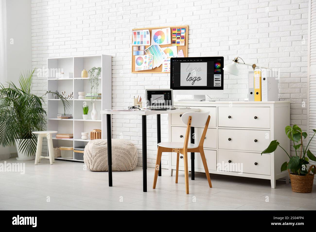 Interior of graphic designer's office with workplace, pin board and ...