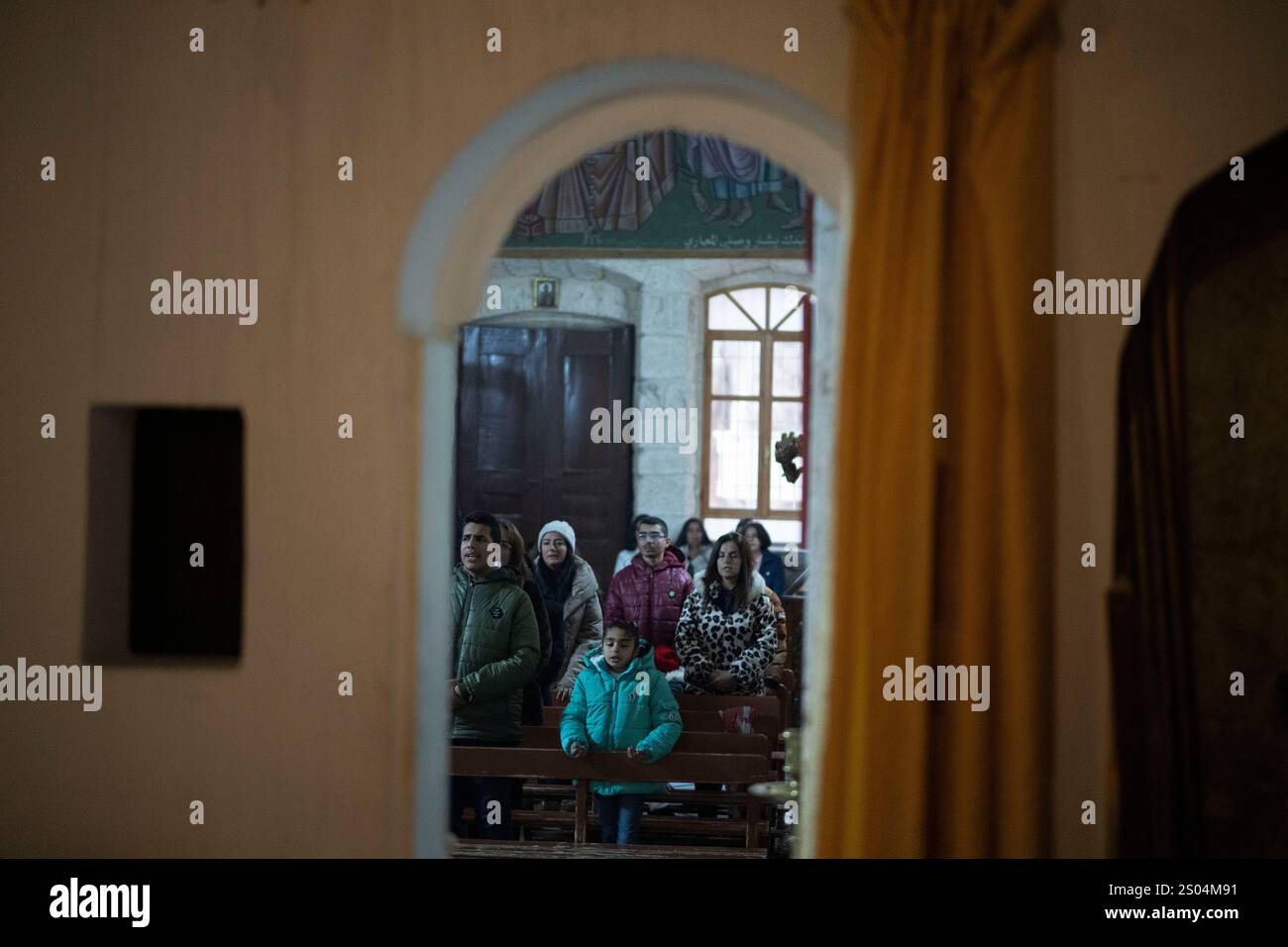 Christians attend the Christmas mass in the Greek Orthodox convent