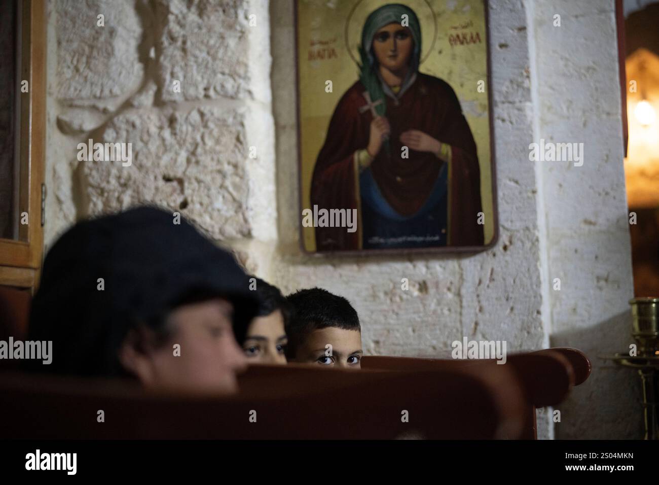 Christians attend the Christmas mass in the Greek Orthodox convent
