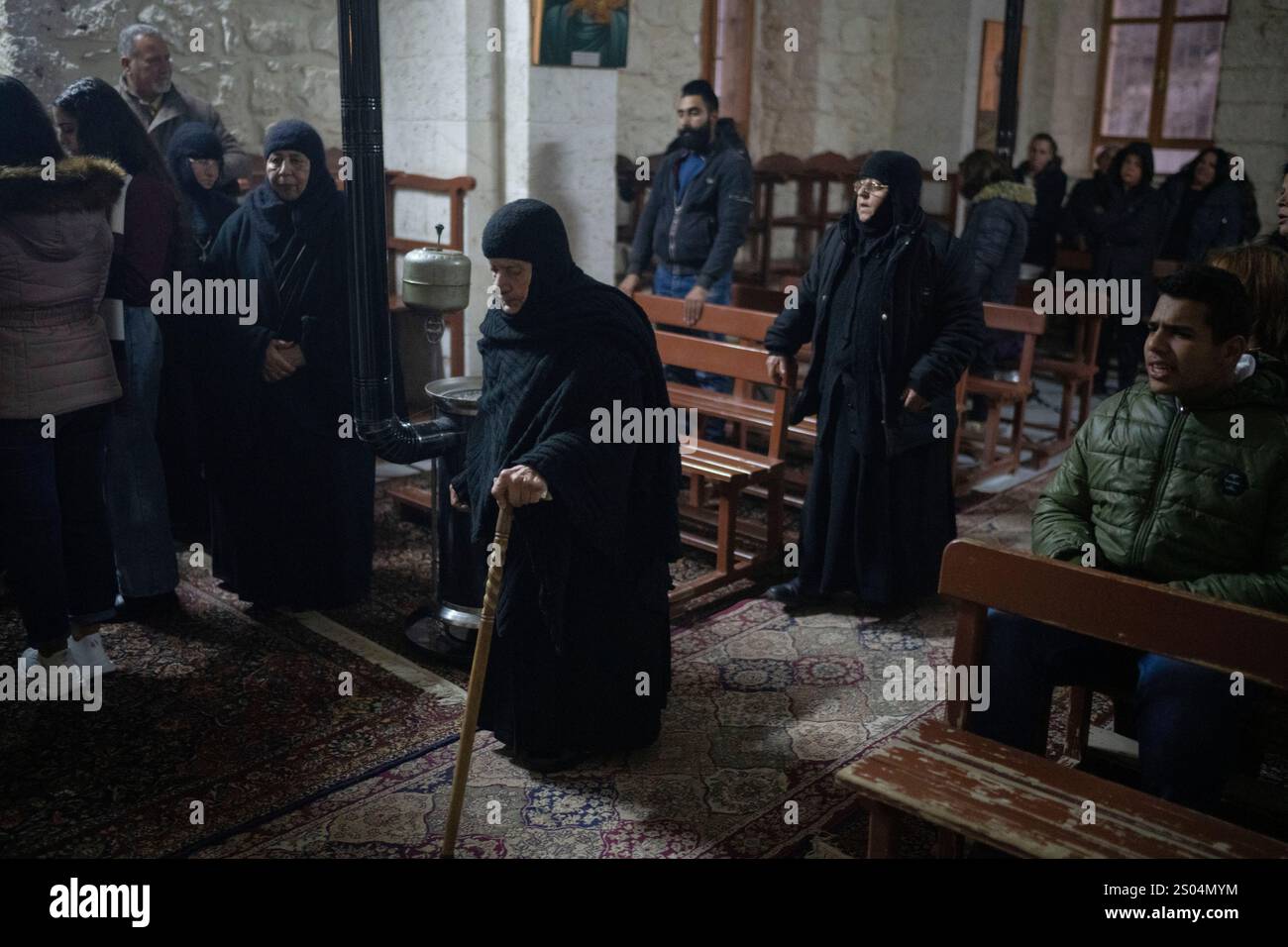 Christians attend the Christmas mass in the Greek Orthodox convent