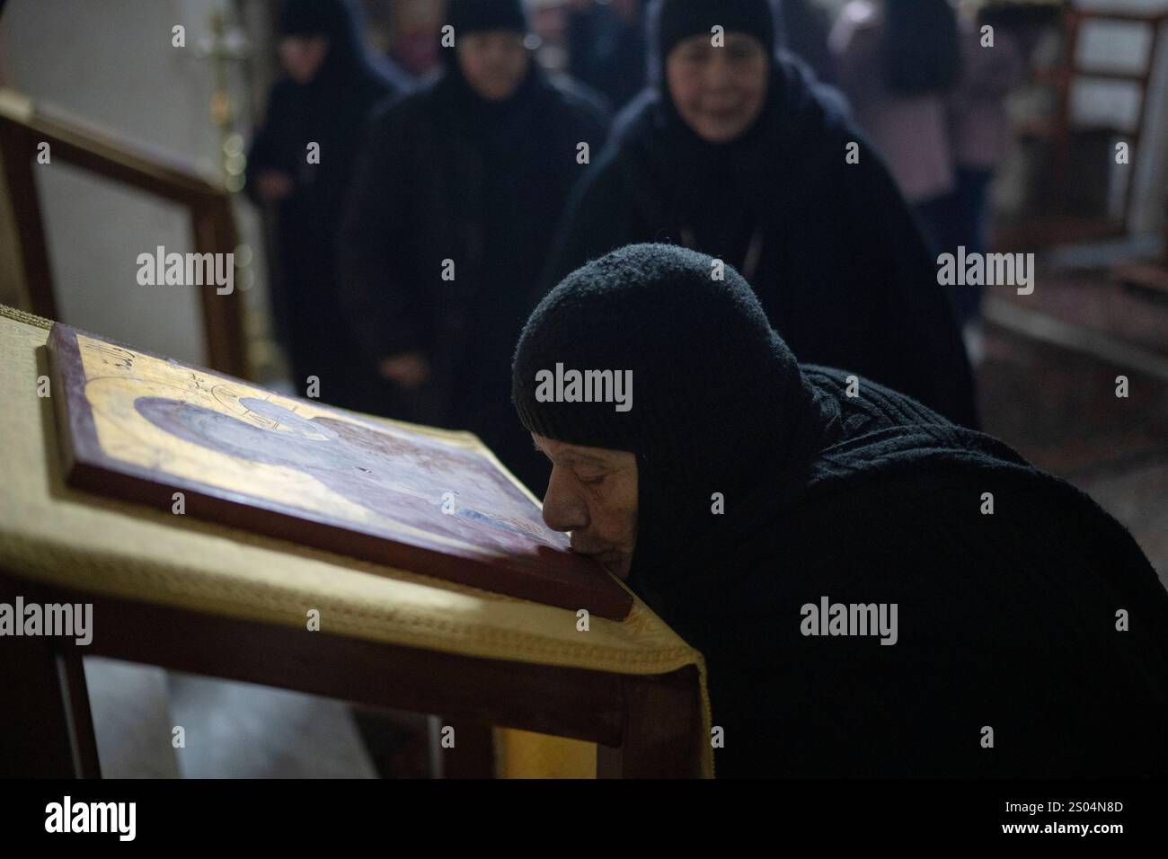 A nun attends the Christmas mass in the Greek Orthodox convent Saint