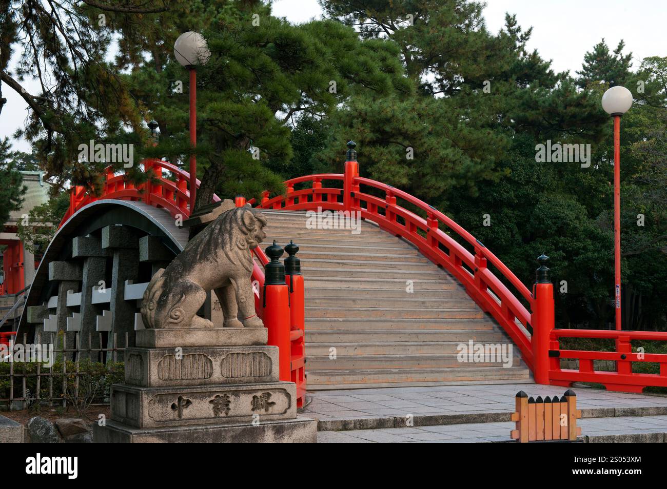 Sumiyoshi Taisha shrine protects Osaka port and the old imperial capitals of Nara and Kyoto.  It is famous for its curved drum bridge over a pond. Stock Photo