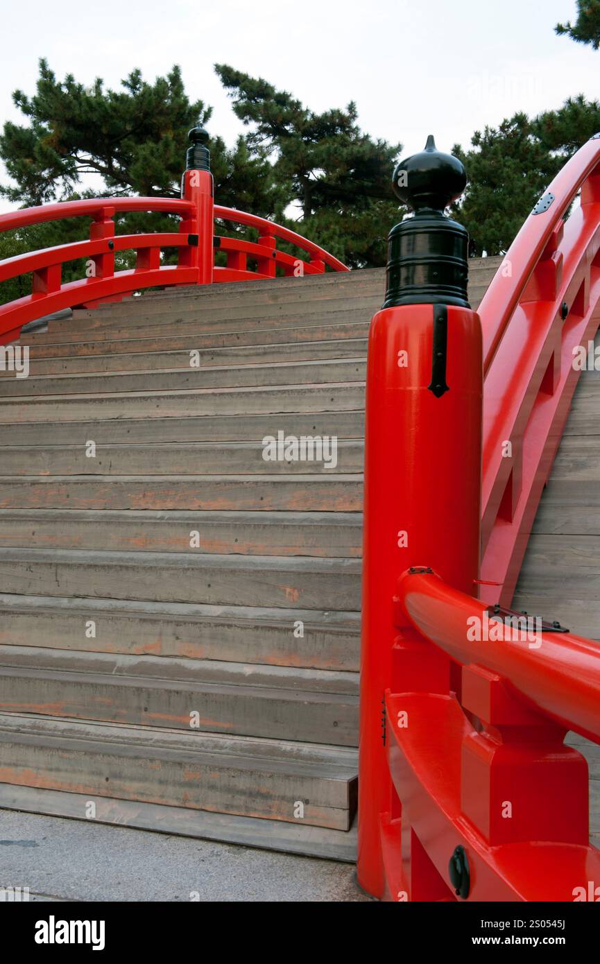 Sumiyoshi Taisha shrine protects Osaka port and the old imperial capitals of Nara and Kyoto.  It is famous for its curved drum bridge over a pond. Stock Photo