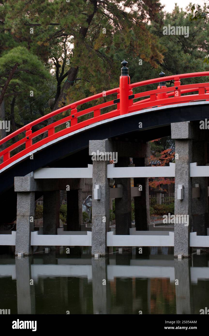 Sumiyoshi Taisha shrine protects Osaka port and the old imperial capitals of Nara and Kyoto.  It is famous for its curved drum bridge over a pond. Stock Photo