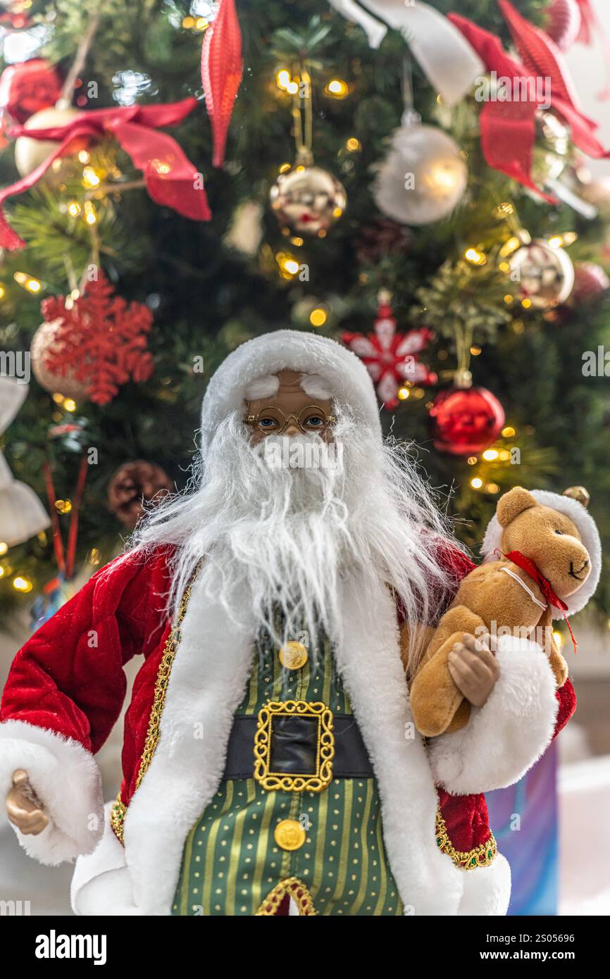 Father Christmas Figure in front of Christmas tree Stock Photo