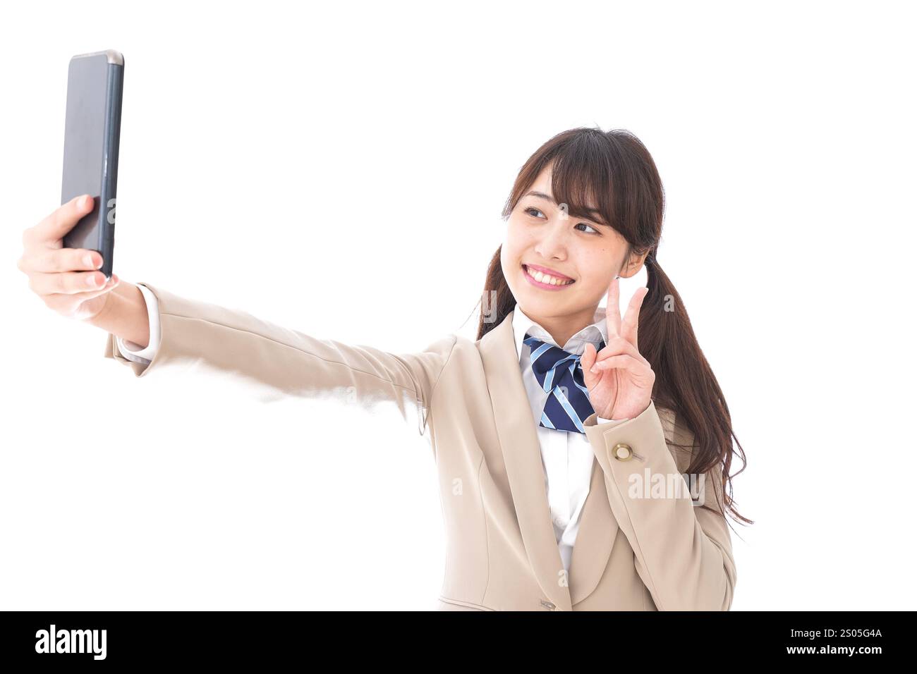 Student in school uniform using a smartphone Stock Photo