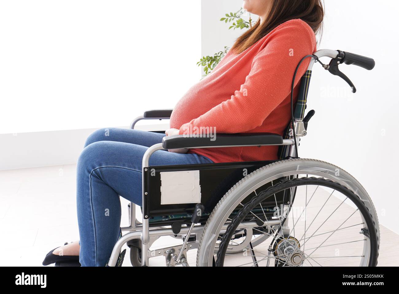 Pregnant woman in wheelchair Stock Photo