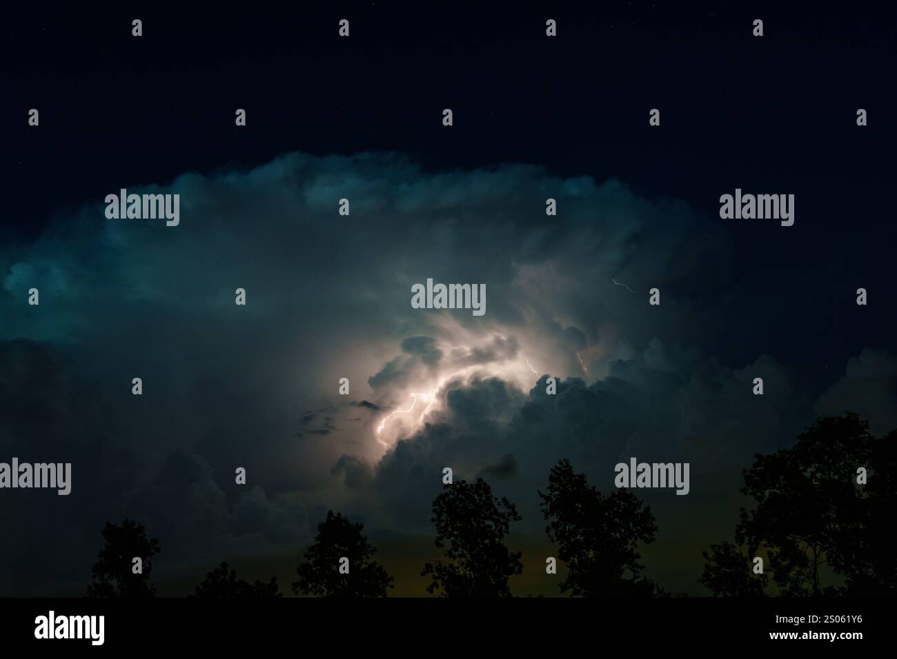Night sky illuminated by a bolt of lightning during a thunderstorm in ...