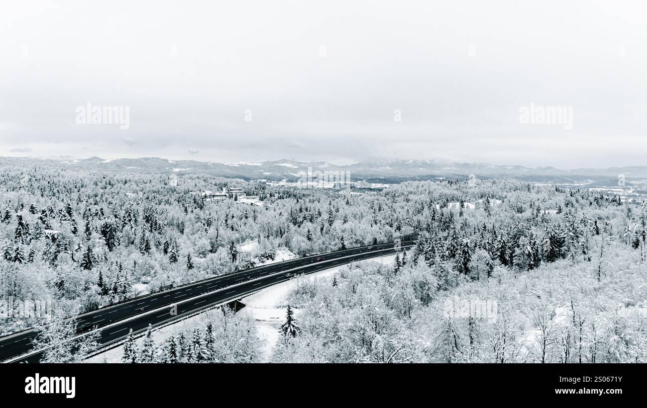 Aerial View of Snowy Forest with Highway Stock Photo - Alamy