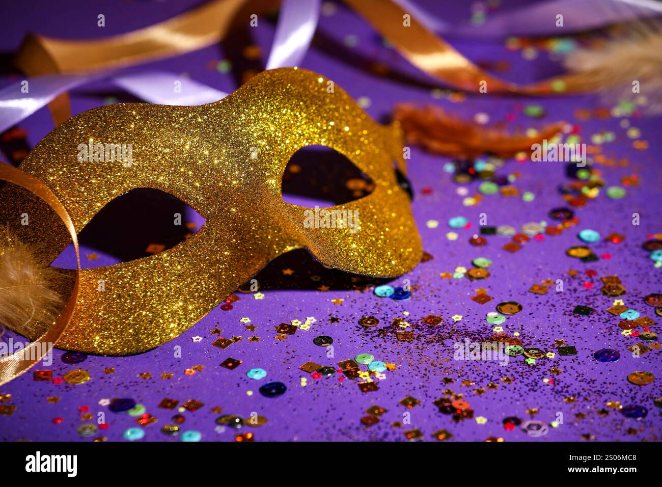 Beautiful carnival mask, ribbons and confetti on purple background ...
