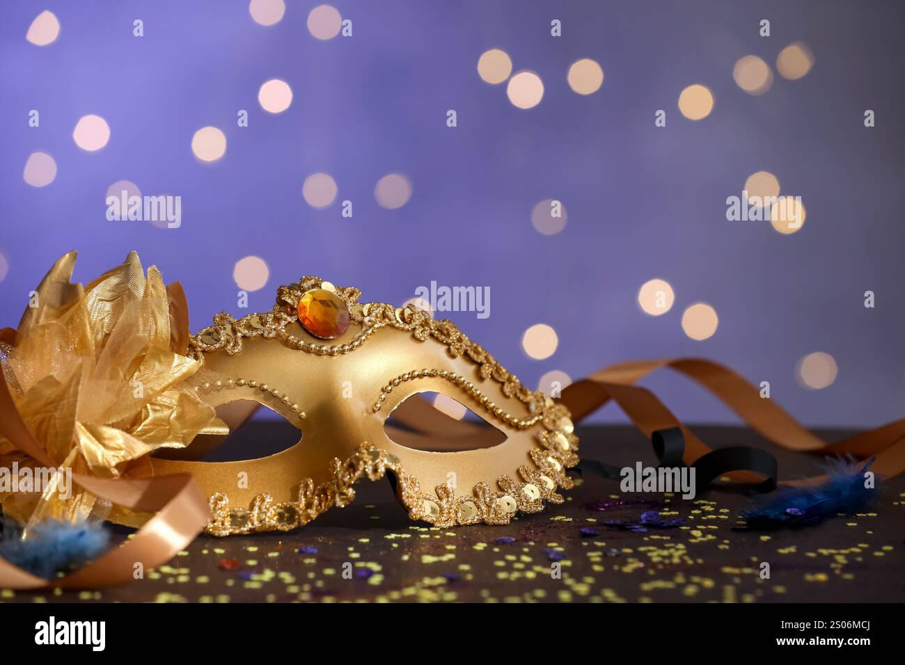 Beautiful carnival mask, ribbons and confetti on color background with ...