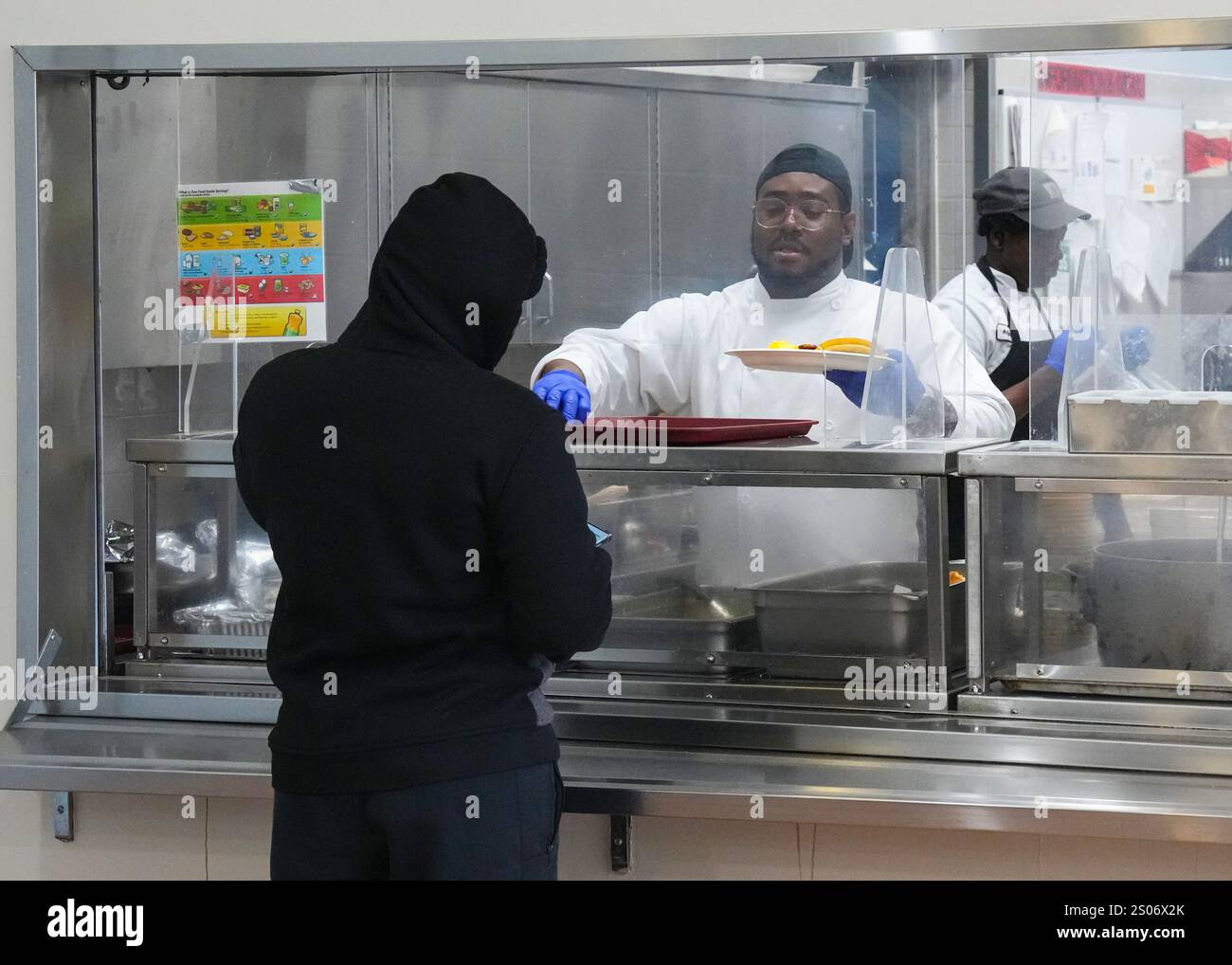A resident is served Holiday Brunch at Bethlehem United Shelter, in