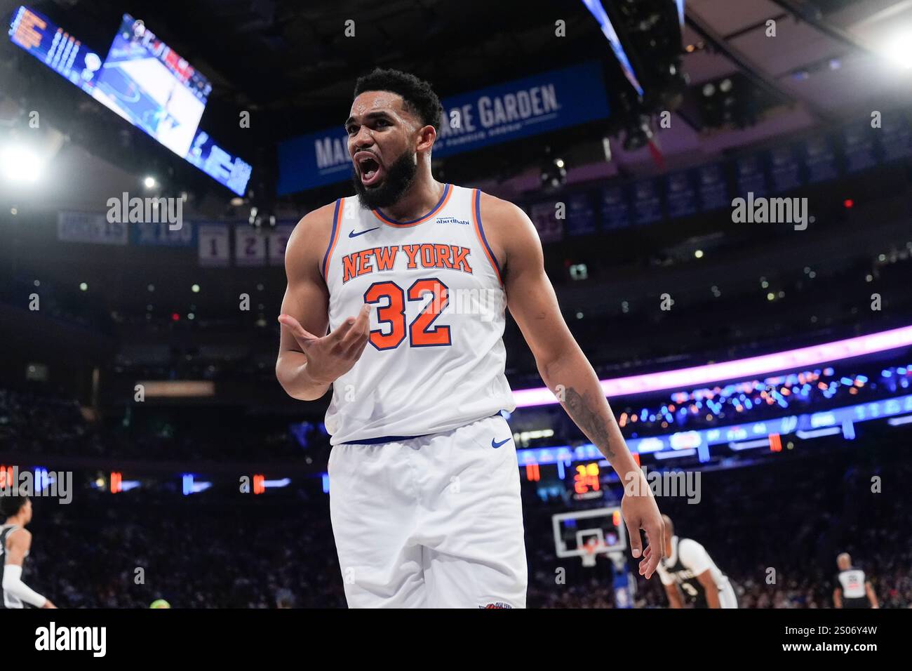New York Knicks' Karl-Anthony Towns reacts after getting hit in the ...