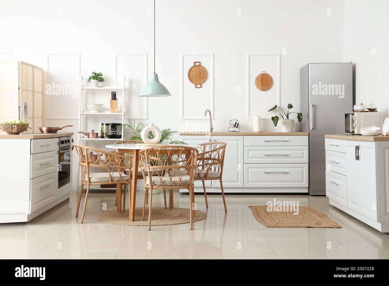 Interior of light kitchen with white counters, shelf unit and dining ...
