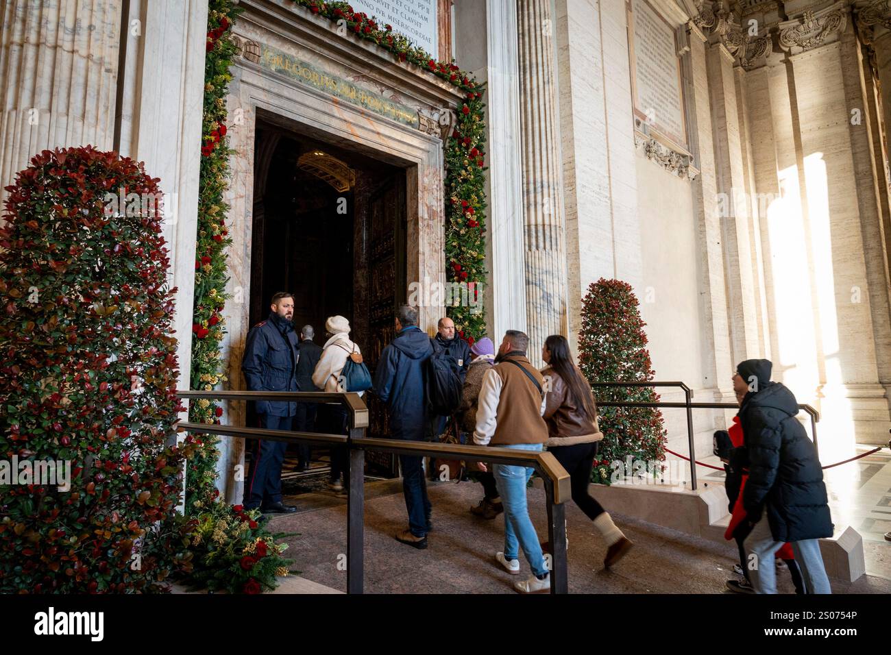 Faithful walk through the Holy Door of St. Peter's Basilica at the