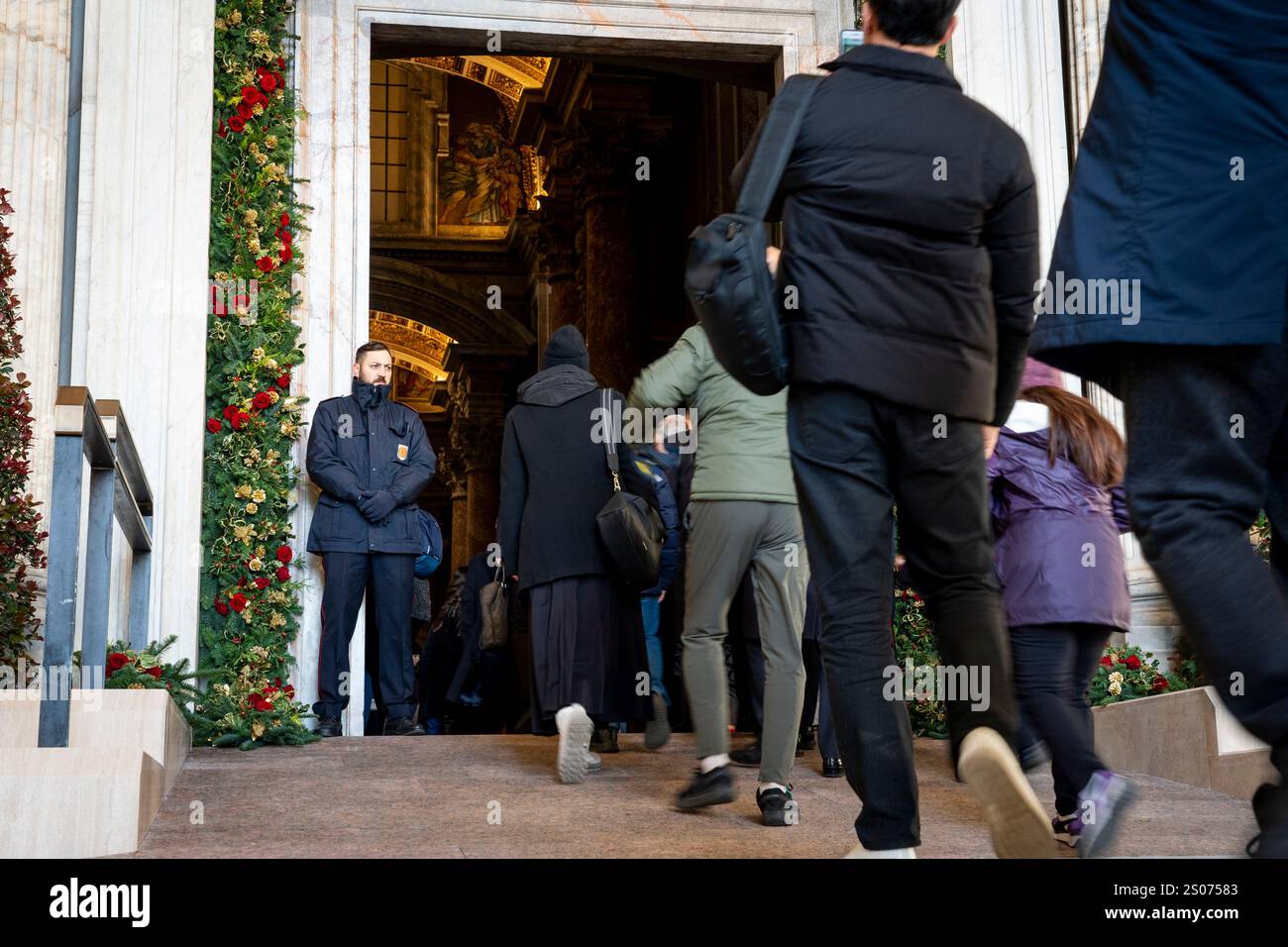 Faithful walk through the Holy Door of St. Peter's Basilica at the