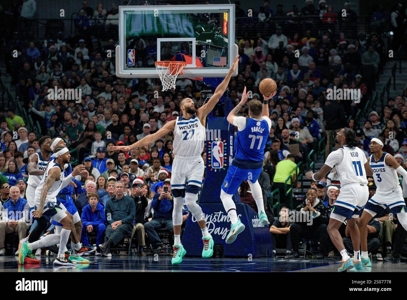 Dallas Mavericks guard Luka Doncic (77) attempts a shot over Minnesota ...