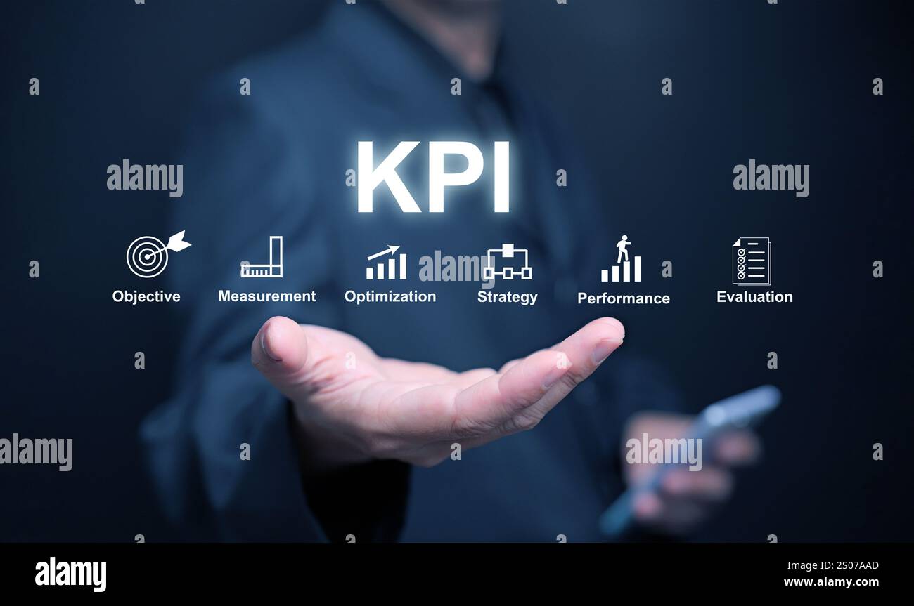 KPI key performance indicator. A businessman, in his hand, uses KPIs to measure progress of his business, project, or work over time to reach the goal Stock Photo