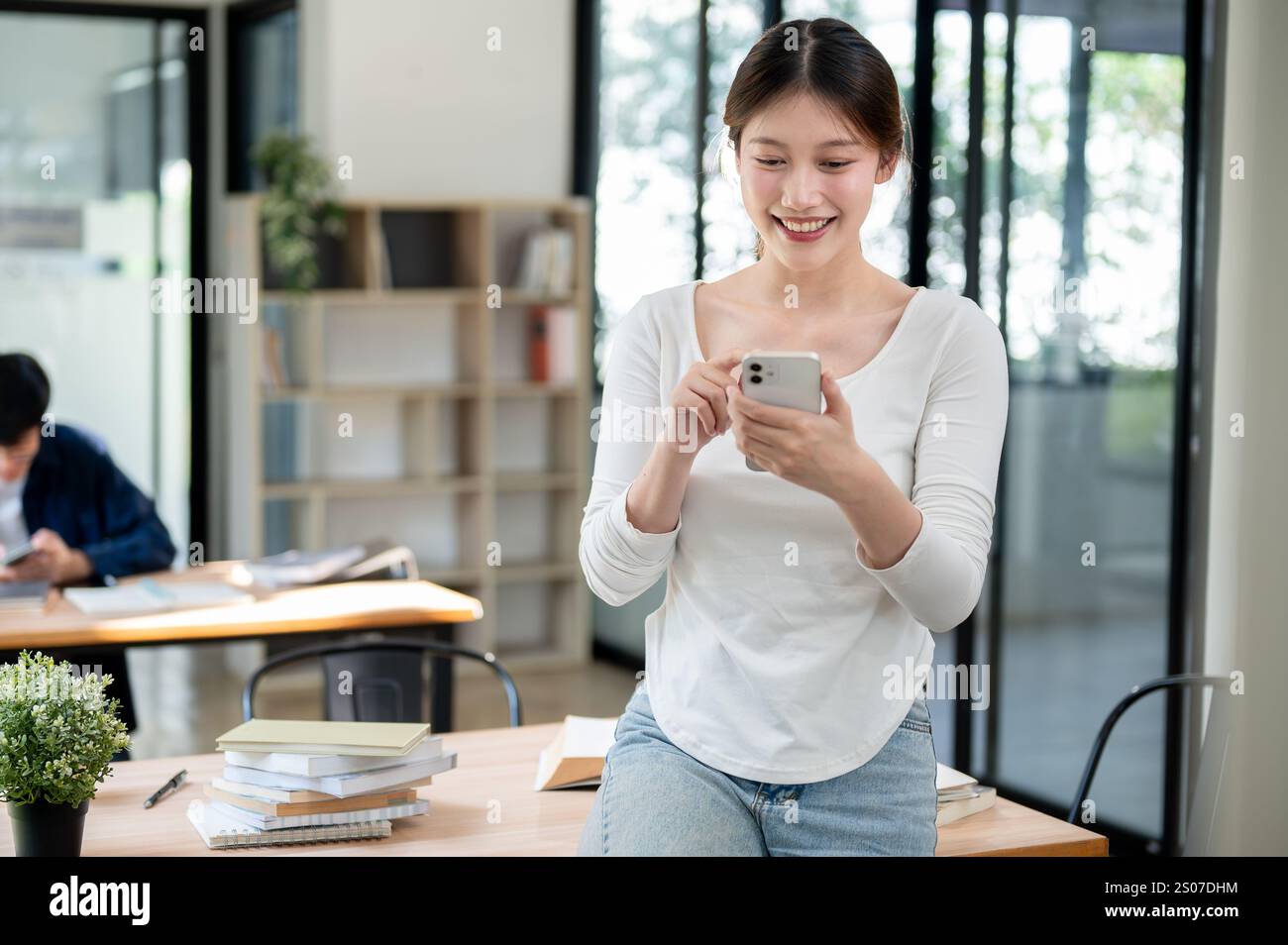 A portrait of a beautiful, smiling young Asian female college student ...