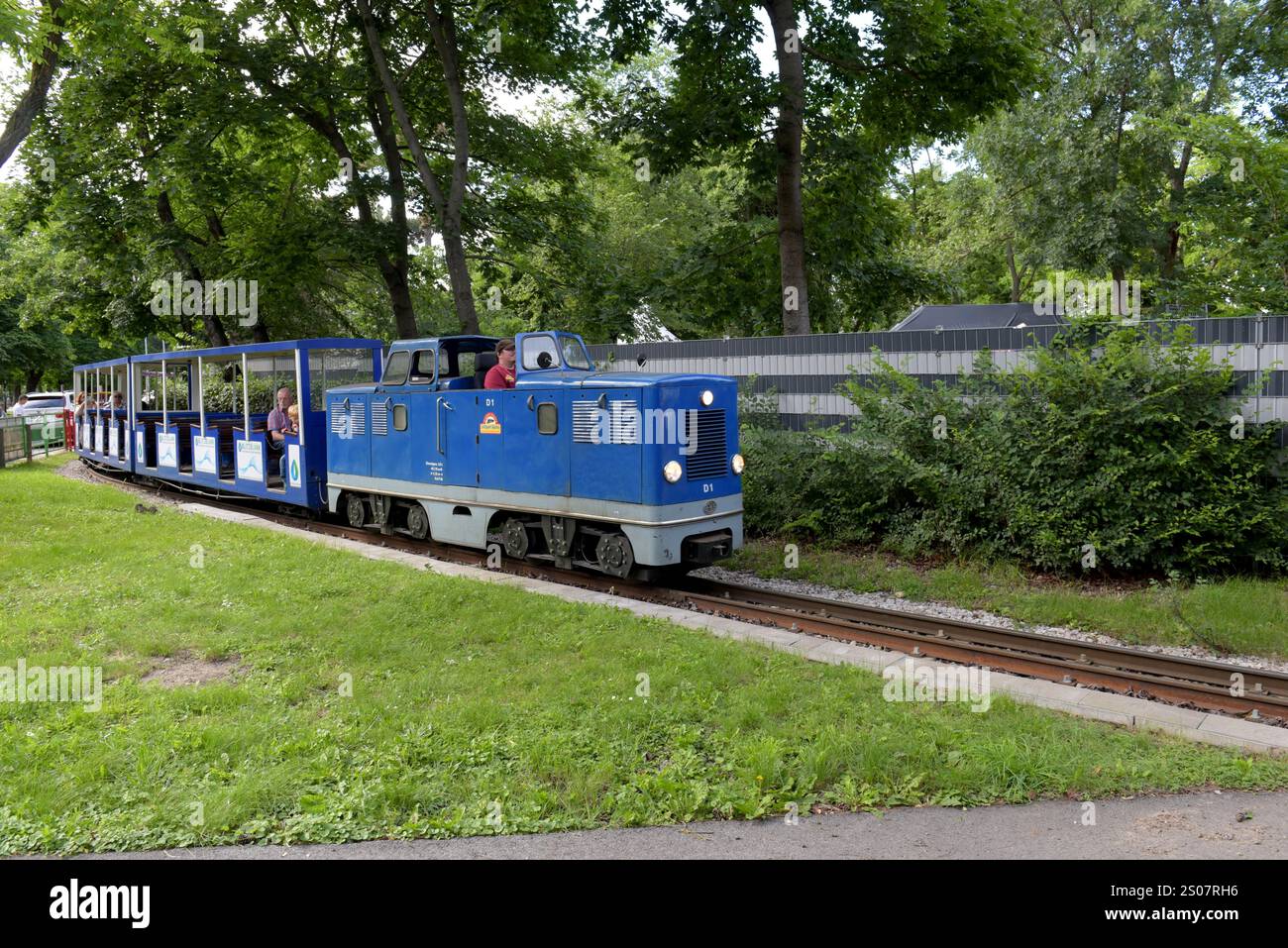 Tourists on a narrow gauge train on the Prater Liliputbahn, Prater Park,  Vienna, Austria, June 2024 Stock Photo