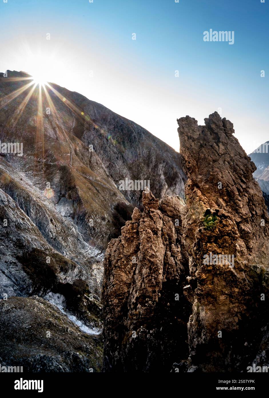 A stunning mountain landscape at sunrise, featuring jagged rock ...
