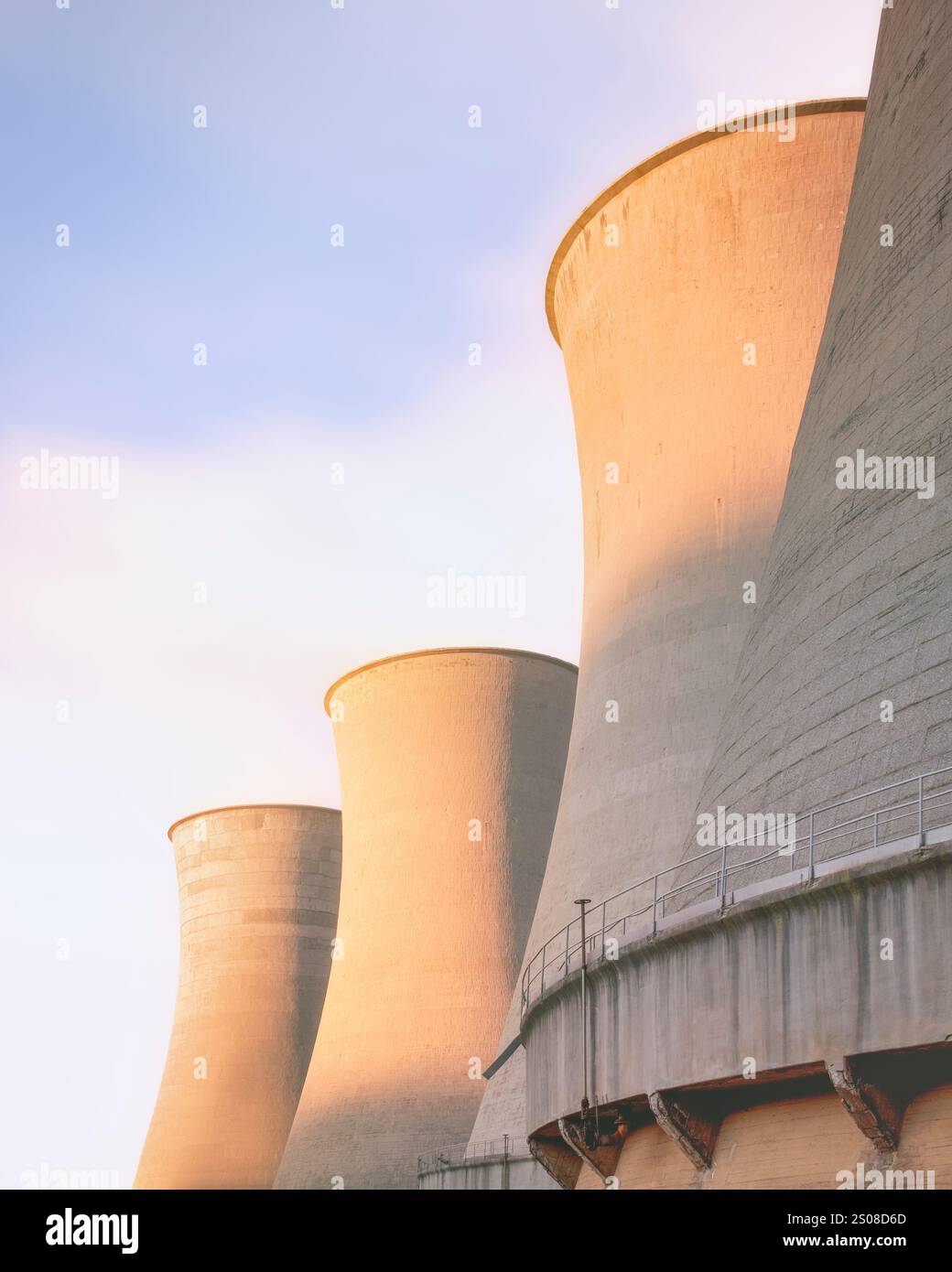 Cooling towers in geothermal power plant at sunset. Larderello, Tuscany region, Italy. Geothermal power is a form of alternative and sustainable energ Stock Photo