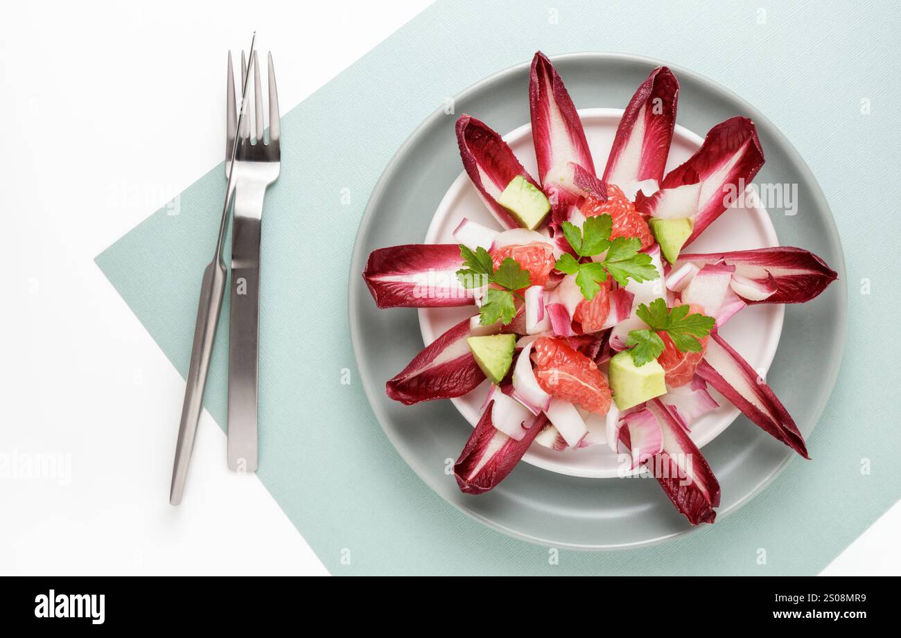 Red chicory salad with grapefruit and avocado Stock Photo