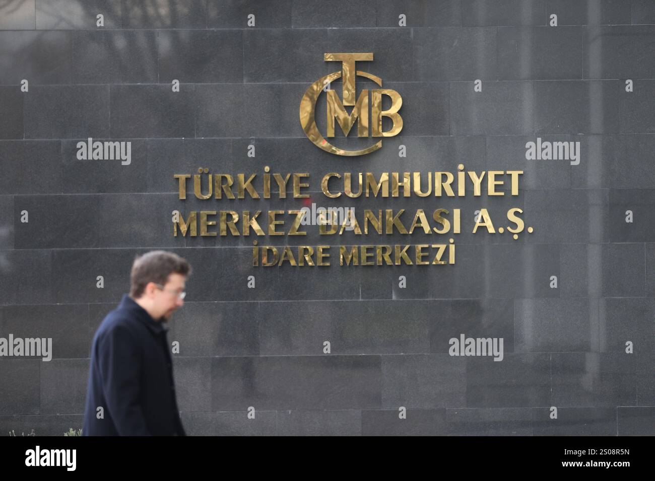 241226-ankara-dec-26-2024-xinhua-a-man-walks-past-the-logo