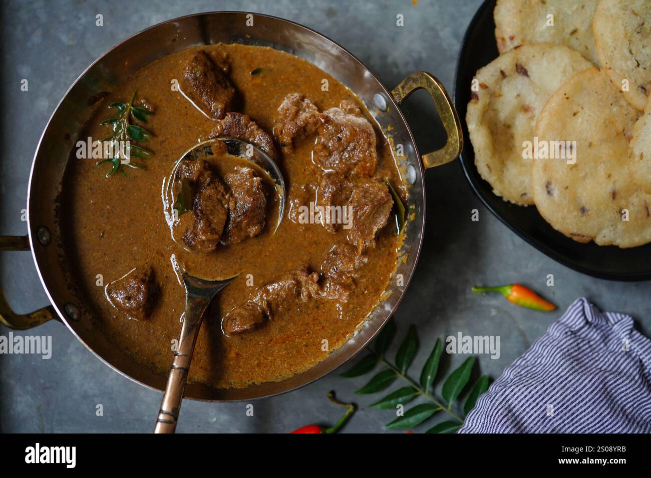 Lamb curry served with Ney Pathal | Kerala breakfast meal Stock Photo ...