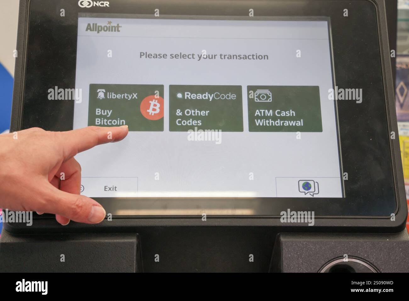 A Bitcoin ATM is stationed near the front door of a CVS Pharmacy in ...