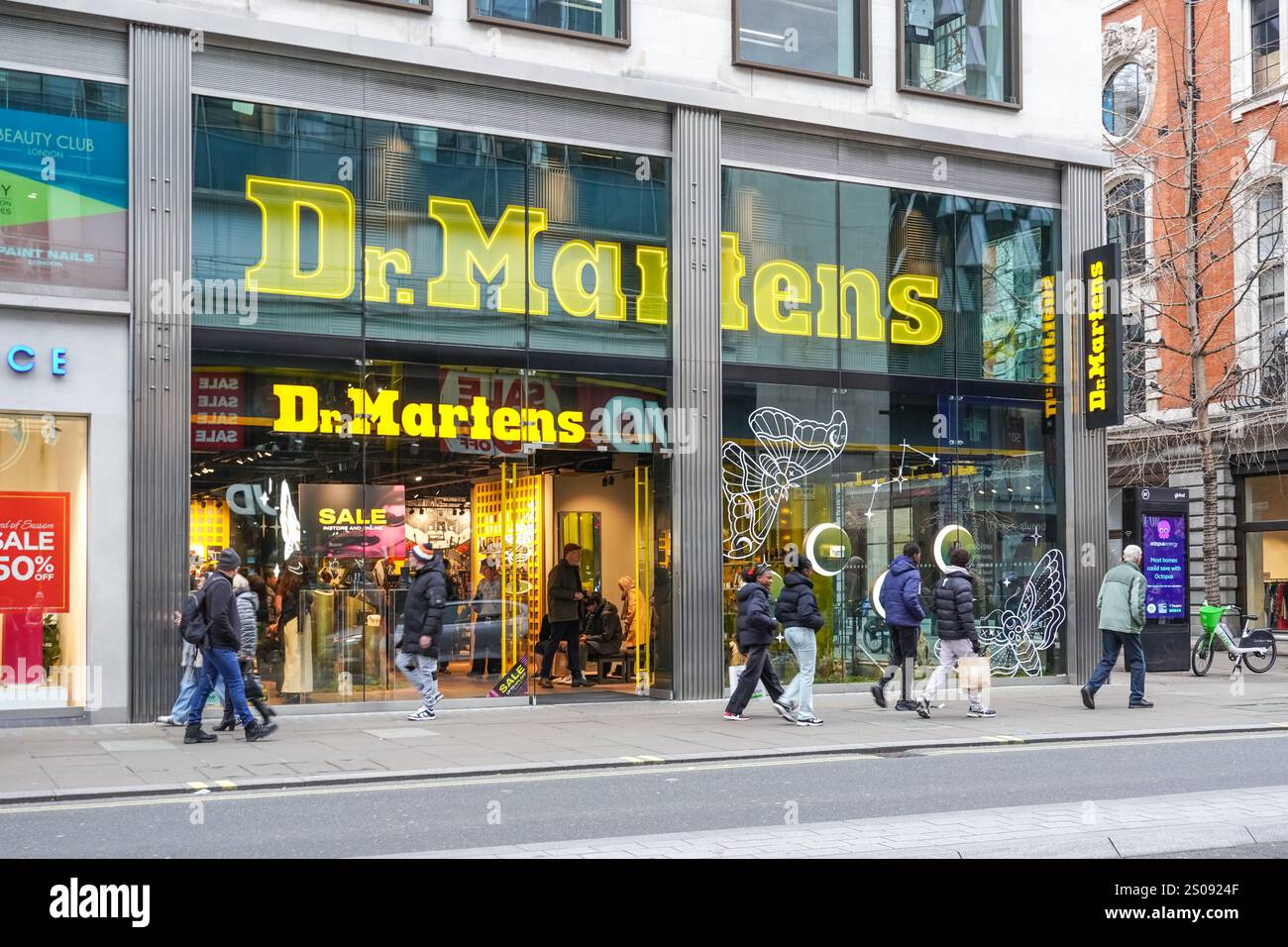 Shoppers outside Dr. Martens store on Oxford Street, London England United Kingdom UK Stock Photo
