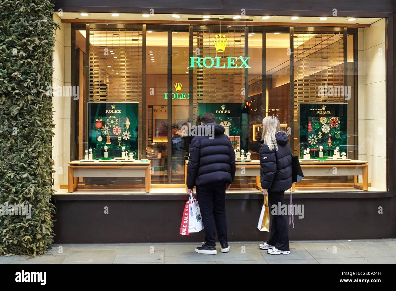 Shoppers outside Rolex store on Oxford Street, London England United Kingdom UK Stock Photo
