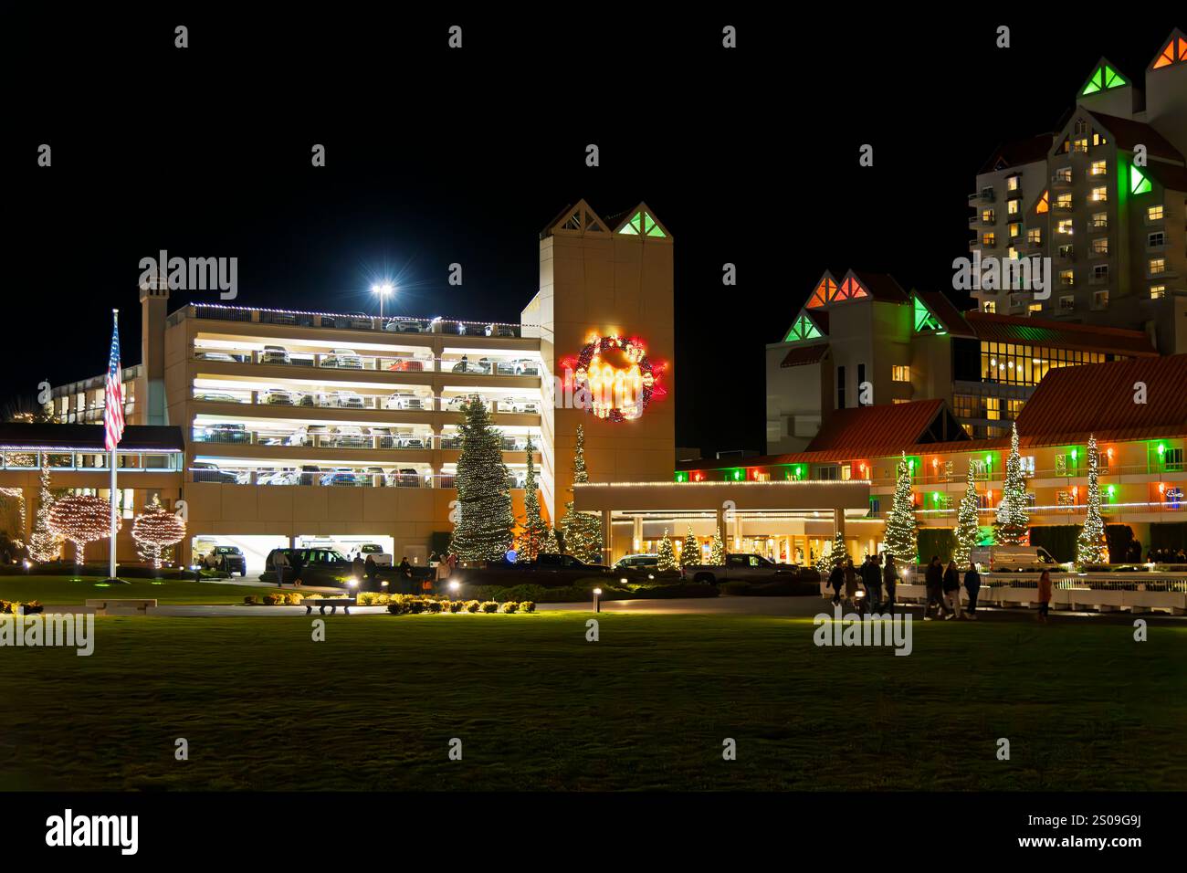 The illuminated lakefront downtown resort with colorful Christmas lights on the buildings, trees and marina in Coeur d'Alene, Idaho USA. Stock Photo