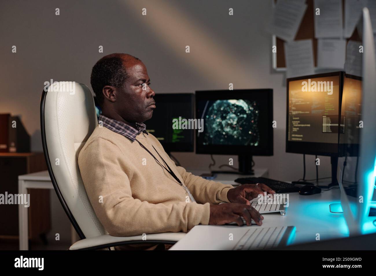 Serious African American IT manager or programmer decoding data on ...