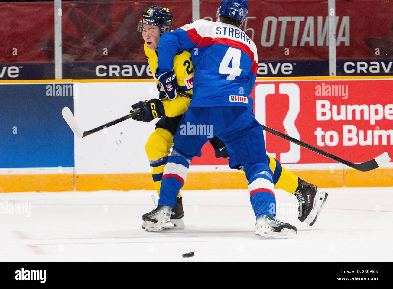 Slovakia's Maxim Strbak (4) collides with Sweden forward David Granberg
