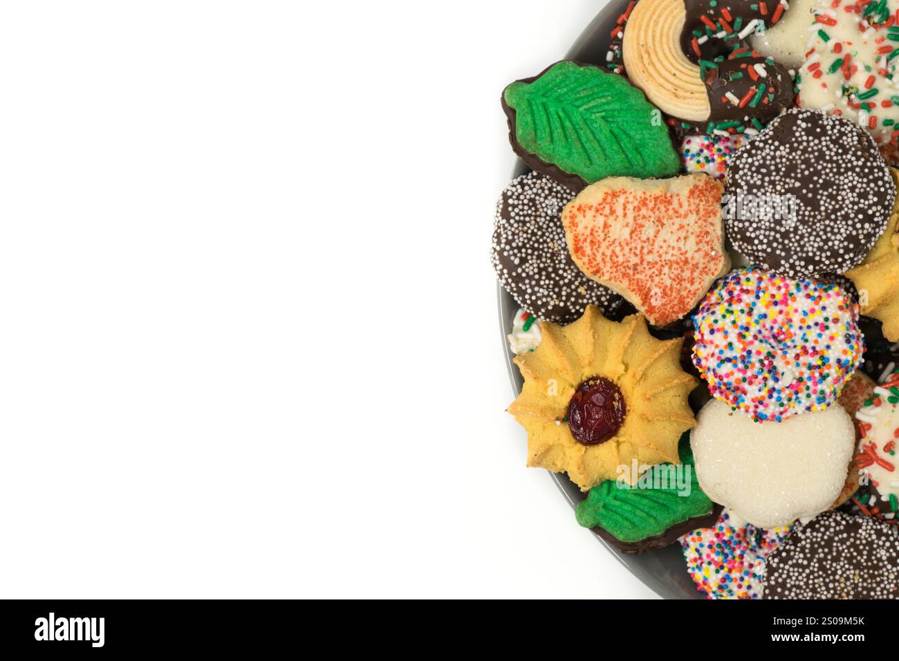 Christmas cookies assorted shortbread partial plate snacks white background copy space. Stock Photo