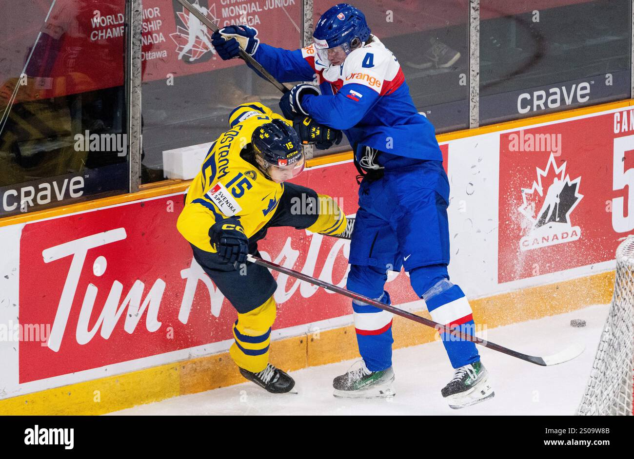 Slovakia's Maxim Strbak (4) hits Sweden forward David Edstrom (15) into