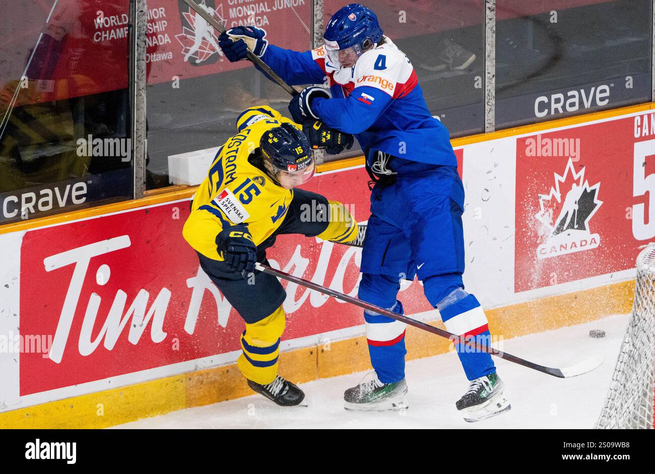 Slovakia's Maxim Strbak (4) hits Sweden forward David Edstrom (15) into
