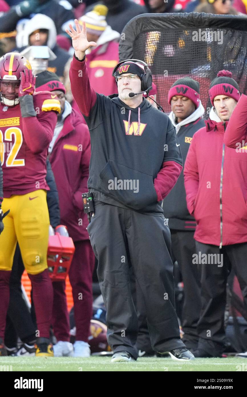 Washington Commanders head coach Dan Quinn signals to his players