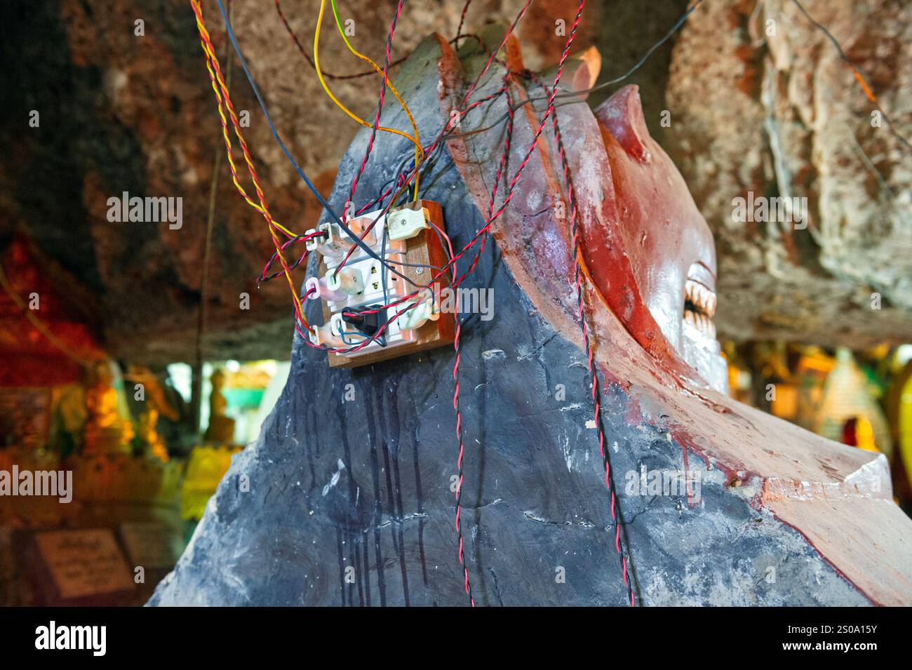 Primitive tangled electrical wireing setup on the back of a stone ...