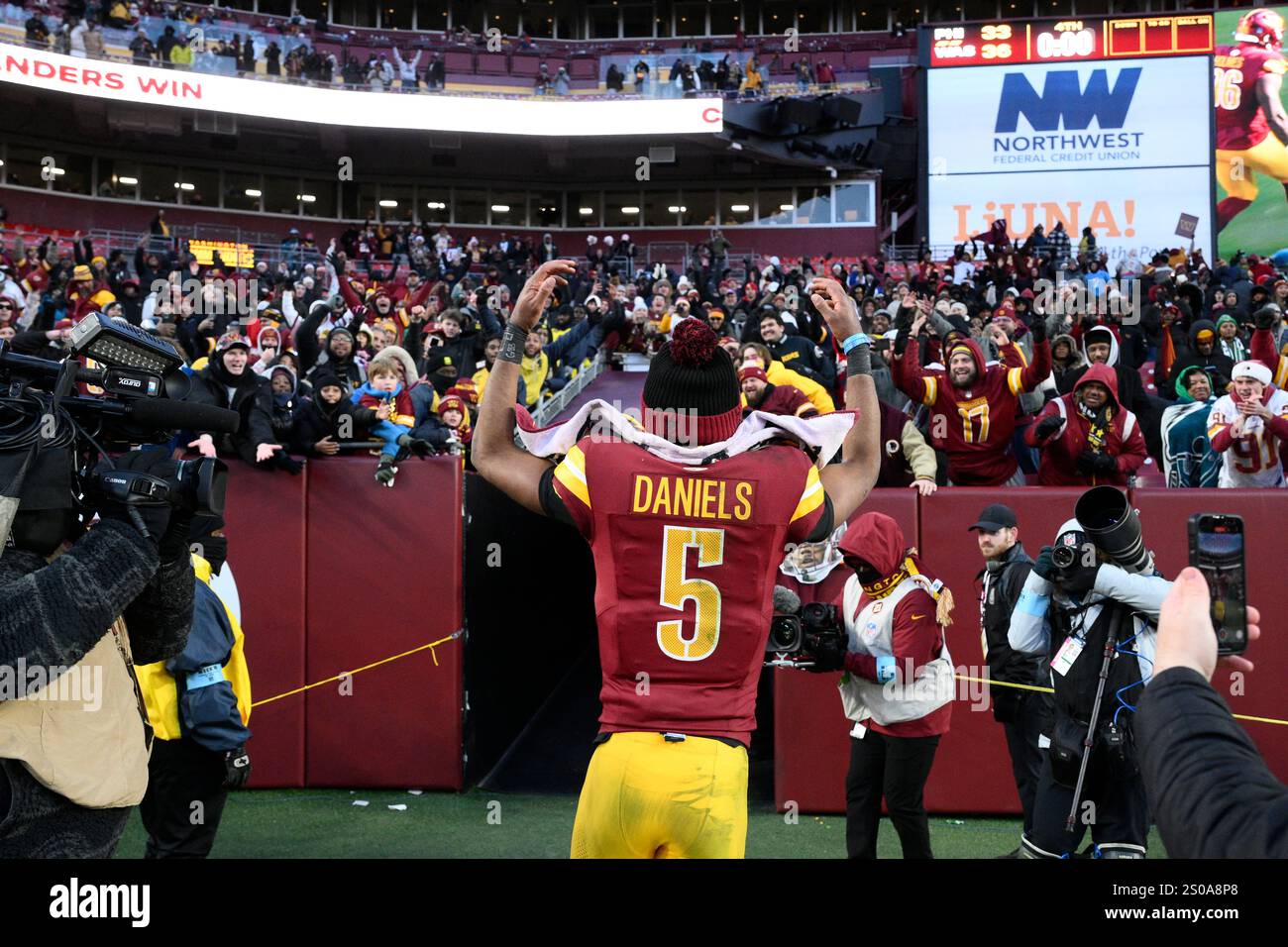 Washington Commanders quarterback Jayden Daniels (5) reacts after an