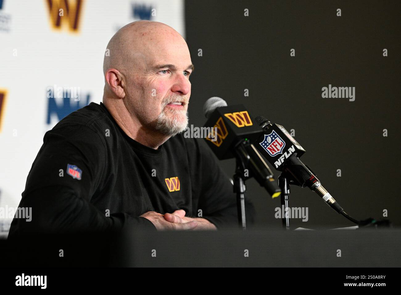 Washington Commanders head coach Dan Quinn talks to the media after an