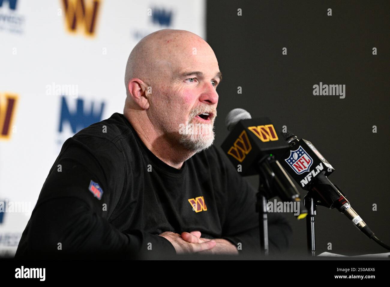 Washington Commanders head coach Dan Quinn talks to the media after an