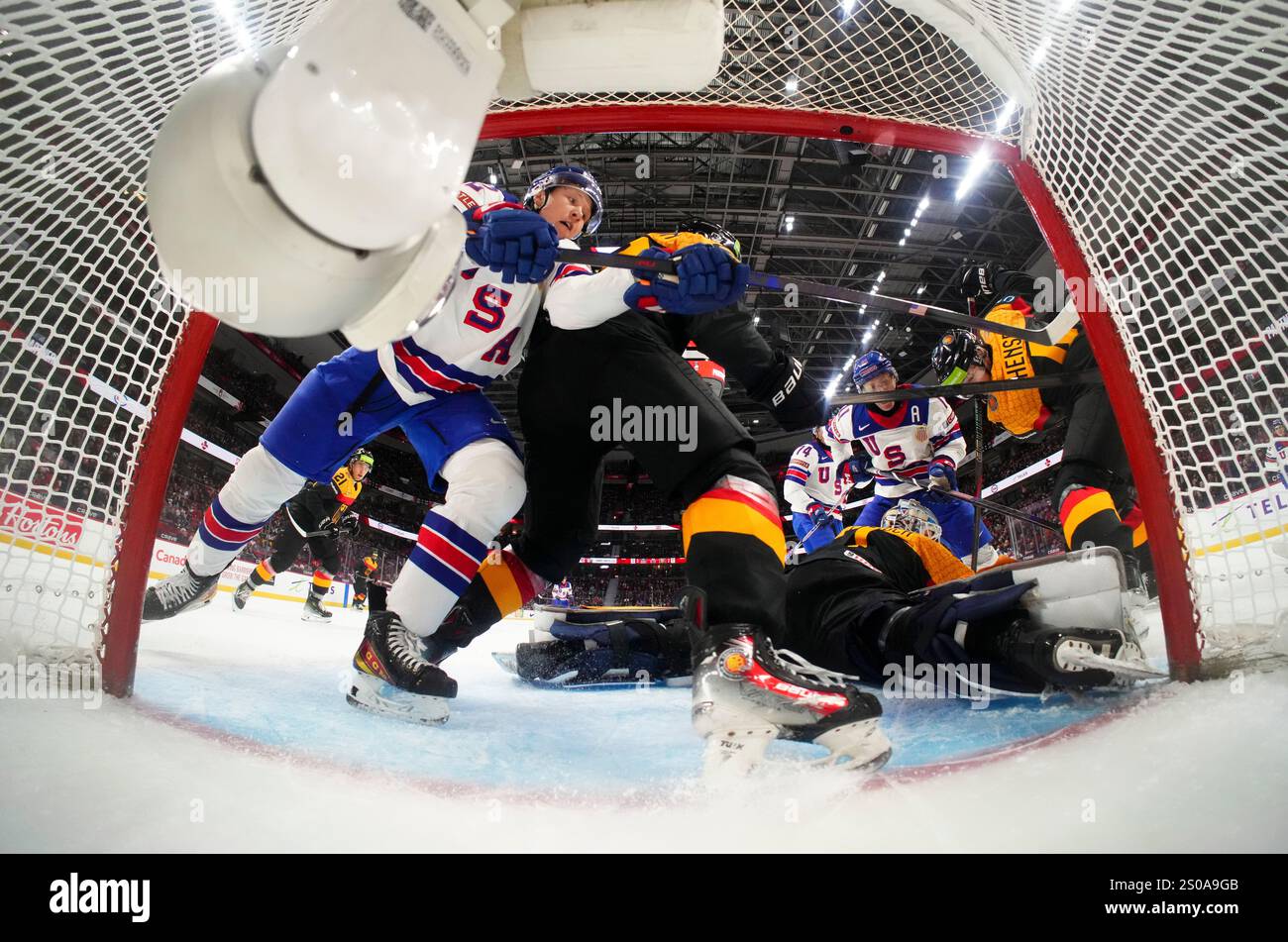 Germany goaltender Nico Pertuch (1) defends his net as a USA player